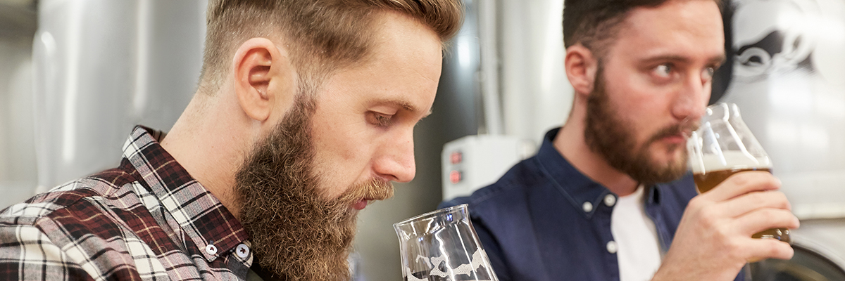 two men drinking beer tasting 1200 400 banner