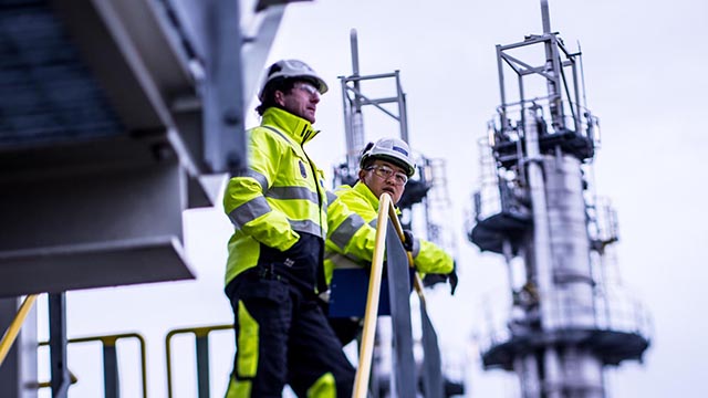 oil refinery workers discussing outside