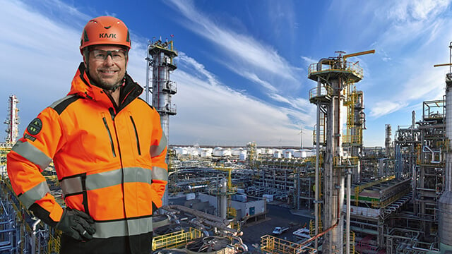 proud engineer in front of oil refinery