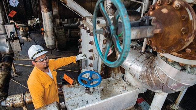 asian oil refinery worker