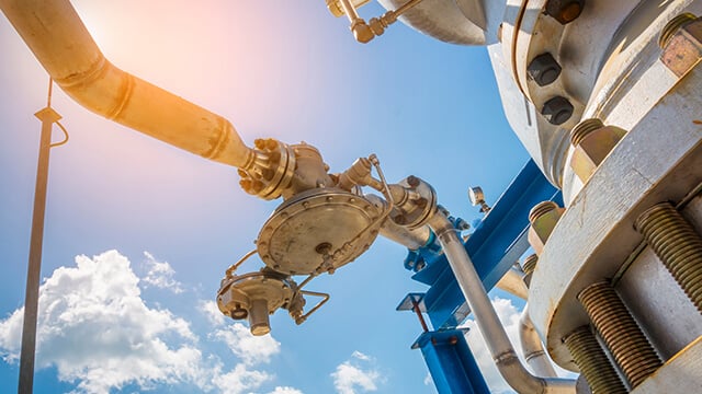 Industrial pipes with blue sky and white clouds