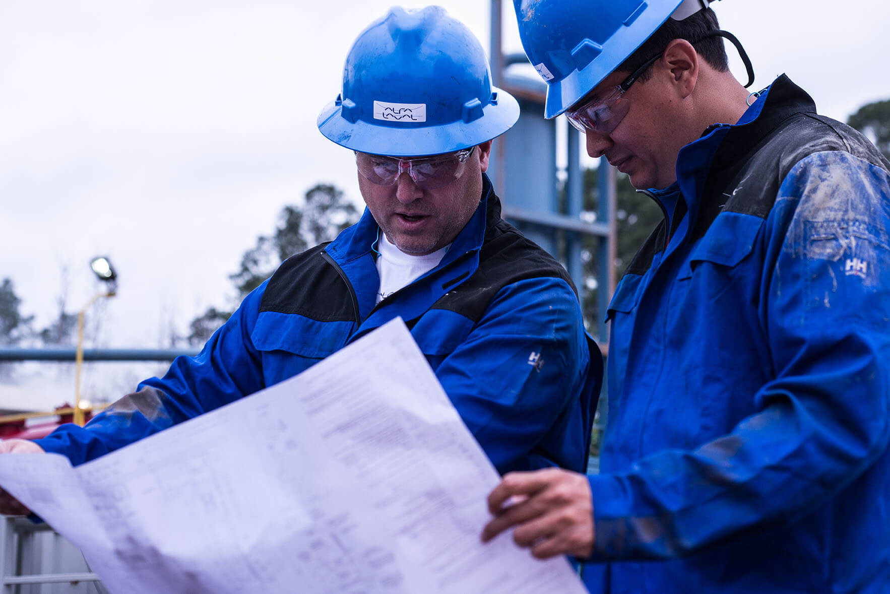 Two men with blue clothes and helmets